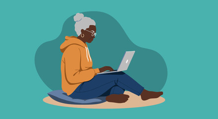 Elderly Black woman sits comfortably, focused on her laptop, embracing technology and digital learning. Modern senior lifestyle.