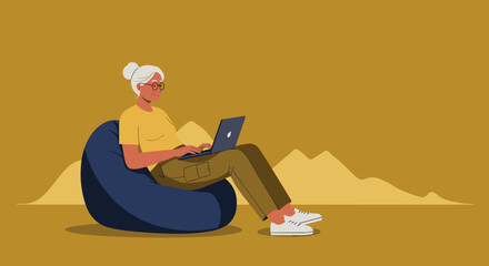 Senior woman comfortably using a laptop on a bean bag chair, embracing technology for online learning or remote work.