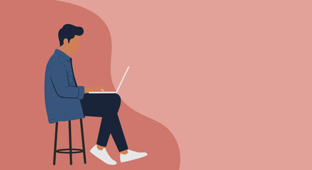 Focused man sitting on a stool, typing on his laptop. Represents remote work, online learning, or digital lifestyle. Ample copy space.