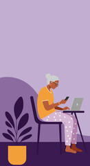 Elderly woman comfortably working from home on a laptop, holding her phone. Represents modern senior life, remote work, or digital communication.