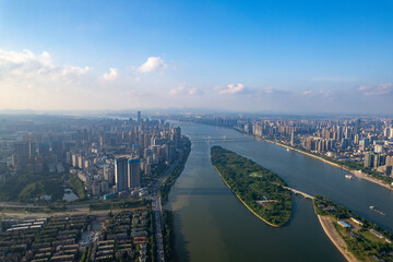 Changsha City, China: Aerial view reveals a sprawling urban landscape. A wide river flows through,...