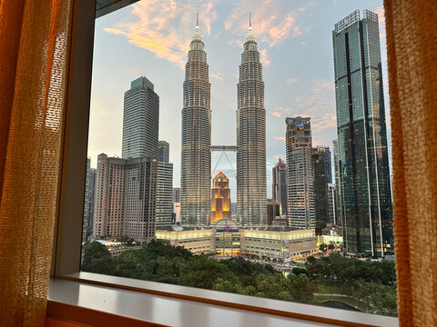 Petronas Towers Kuala Lumpur Malaysia skyline with twin skyscrapers at sunset, modern architectural landmark - Powered by Adobe