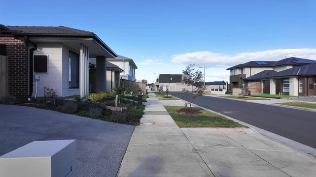 Residential street in Wyndham Vale, Victoria, Australia, with modern houses, driveways, and a quiet suburban neighborhood. Concept of new housing development, real estate, and community in Melbourne