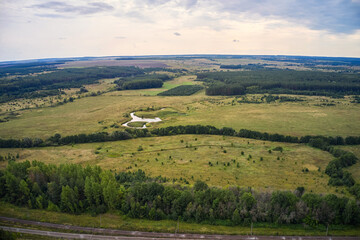 Fototapeta premium view from the height of the endless fields and forests in summer