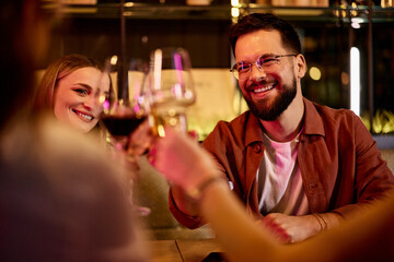 Friends Celebrating Together With Drinks at a Cozy and Modern Restaurant