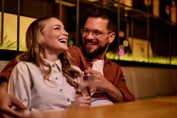 Smiling Couple Enjoying a Moment of Joy and Laughter in a Cozy Setting