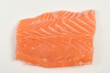 A detailed close-up of a single raw salmon fillet portion, highlighting the rich orange color and natural texture of the fresh fish
