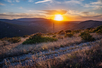 Sunset illuminating Crimean mountains and valleys with colorful sky