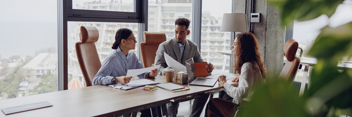 A diverse and skilled group of professionals are collaborating effectively in a stylish conference room setting