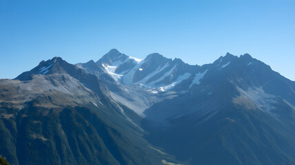 Majestic snow capped mountain peaks under a clear blue sky
