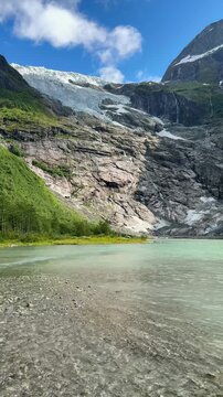 Boyabreen glacier melting into turquoise lake in Jostedalsbreen National Park, Norway
