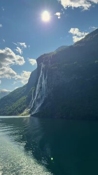 Breathtaking view of the Seven Sisters waterfall flowing into the Geirangerfjord, a UNESCO World Heritage site