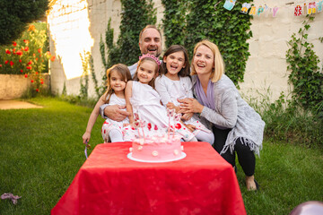 Joyful family celebration in a sunny backyard garden
