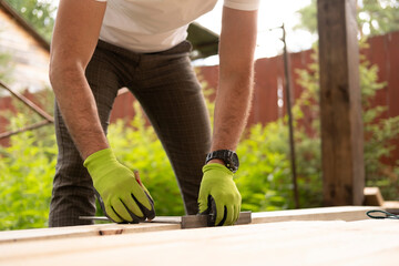 Men's hands, the master makes the layout of building materials on the tree. Construction work.