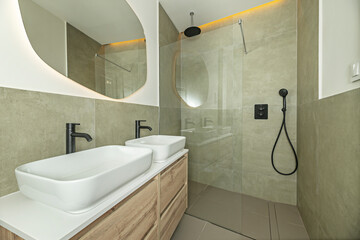 Premium bathroom design with an integrated porcelain sink, a single-lever faucet with a digital display, and a walk-in shower enclosure with silkscreened glass