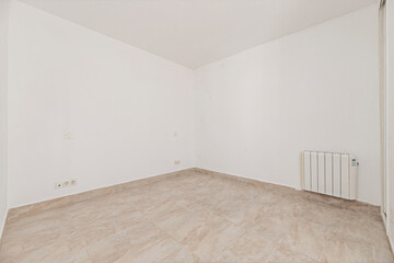 Light, glossy wood flooring in an empty room, reflecting the natural light coming in through the window