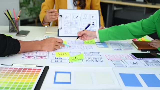 UX graphic designer planning application process development prototype wireframe for web smart phone. Creative digital development agency.
