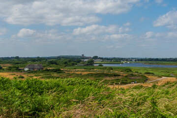 Hengistbury Head, Southbourne, UK - July 1st 2023: The Visitor Centre with Christchurch Harbour and Christchurch Priory in the background.