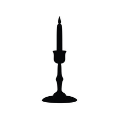 Black silhouette of a burning candle in an ornate candlestick holder