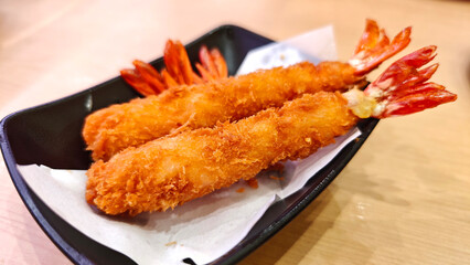  Breaded Torpedo shrimps on black plate