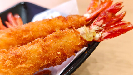  Breaded Torpedo shrimps on black plate