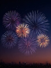 Naklejka premium A vibrant fireworks display lights up the night sky over a city skyline, creating a festive and celebratory atmosphere.