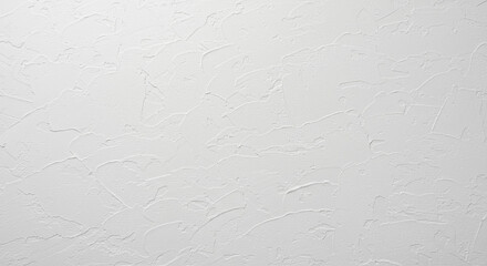 A close up of a textured white wall with subtle patterns and slight color variations