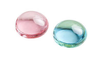 Two translucent spheres, one pink, one teal-blue,  close-up, isolated on black