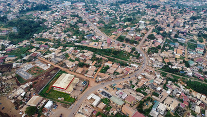 Fototapeta premium Aerial View of a Suburban Neighborhood with Dense Housing and Green Spaces in Africa Cameroon
