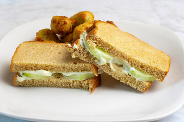 cucumber sandwich served  with broccoli tots