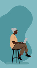 Engaged senior Black woman uses a laptop, representing active aging, digital literacy, remote work, and online education.