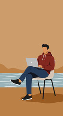 Man working on laptop outdoors by water, embodying remote work and digital nomad lifestyle, symbolizing productivity and freedom.