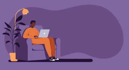 African American man comfortably works from home on his laptop, sitting in an armchair with a floor lamp and plant. Depicts remote work, online education, or leisure activity.
