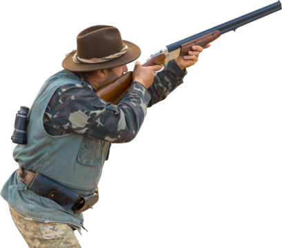 Mature hunter man holding a shotgun and walking through a field