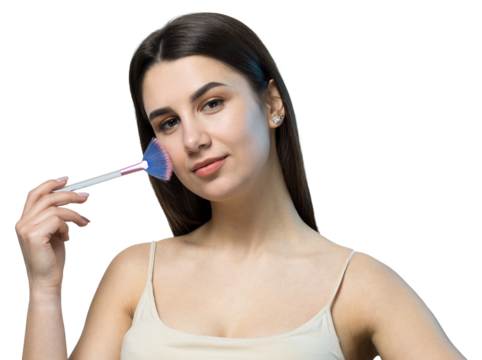 Close-up of a young girl in a light top on a white background making a facial make-up. A pretty woman holds a cosmetic brush near her face and smiles.