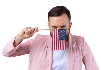 Portrait of a satisfied young man with a beard with an American flag on a red studio background. Great US patriot and defender of freedom.