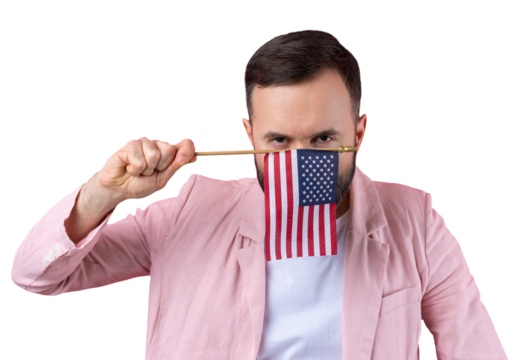Portrait of a satisfied young man with a beard with an American flag on a red studio background. Great US patriot and defender of freedom.