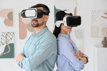 Young couple with VR glasses in modern art gallery