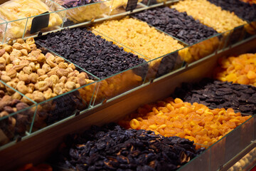 A Colorful and Vibrant Display of Dried Fruits and Nuts in a Bustling Market Setting