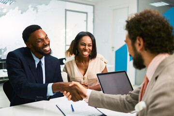 Business people shaking hands after successful meeting in office