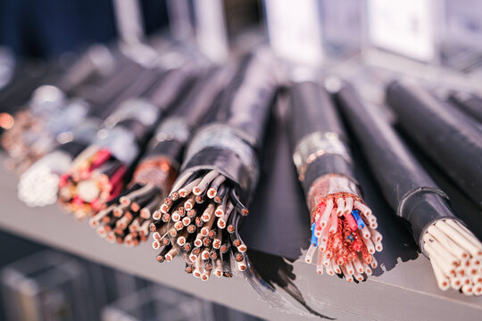 Closeup of various electrical cable and wire types, showing different insulations and conductor materials, for construction and industrial use.