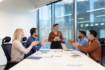 Colleagues engaging in a business presentation and applauding the speaker