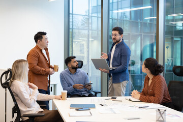 Team members discussing strategies during a collaborative business meeting in a modern office