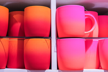 Fototapeta premium A row of brightly colored cups with a pink and orange gradient