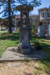 Obraz premium Old Ornamental Water Fountain in Park with Historic Design