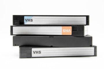 Close-up of stacked video cassettes, isolated on white background