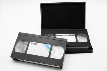 Close-up of video cassettes in their cases, isolated on white background