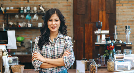 woman stands in front of  counter with  smile on her face