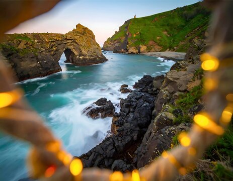 Magical long exposure of ocean waves at a rocky coast with a natural stone arch at dusk.