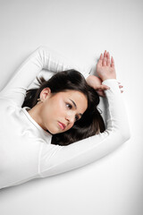 Fototapeta premium Teenage girl lying on floor in thoughtful pose